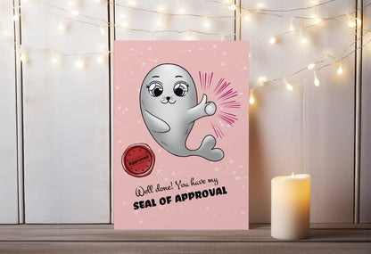 A kawaii greeting card from Rainbow & Bubbles, showing the proud Baby Seal with a big thumbs up, a wav seal of approval. The front says "Well done! You have my seal of approval".