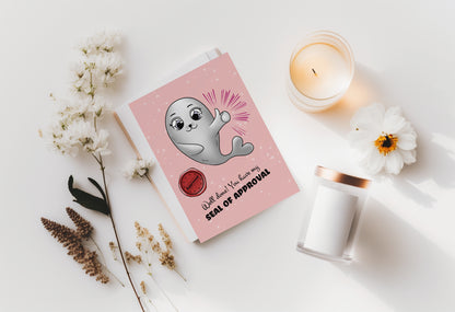 A kawaii greeting card from Rainbow & Bubbles, showing the proud Baby Seal with a big thumbs up, a wav seal of approval. The front says "Well done! You have my seal of approval".