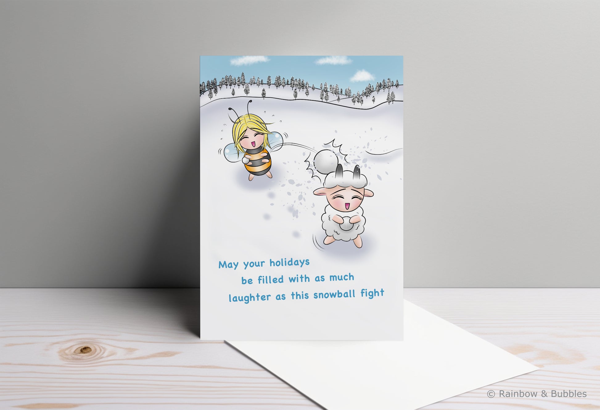 A kawaii greeting card from Rainbow & Bubbles, showing a bee and a sheep having a fun snowball fight.