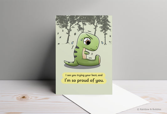 A kawaii greeting card from Rainbow & Bubbles, showing a t-rex stretching and struggling to touch his toes with his little arms.